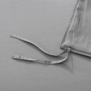 Gray satin fabric with a ribbon on a gray background