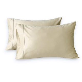 Two beige satin pillowcases on a white background