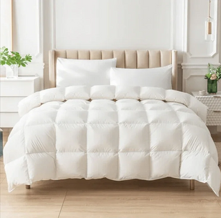 White comforter on a bed in a bright bedroom setting
