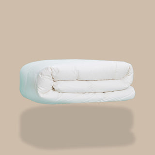 White comforter on a beige background