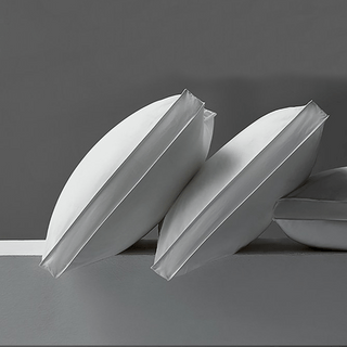 Two white paper boats on a gray background