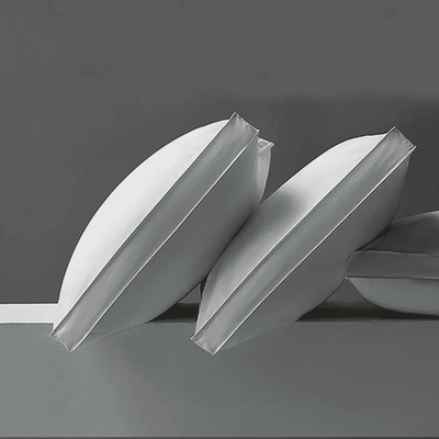 Two white paper boats on a gray background